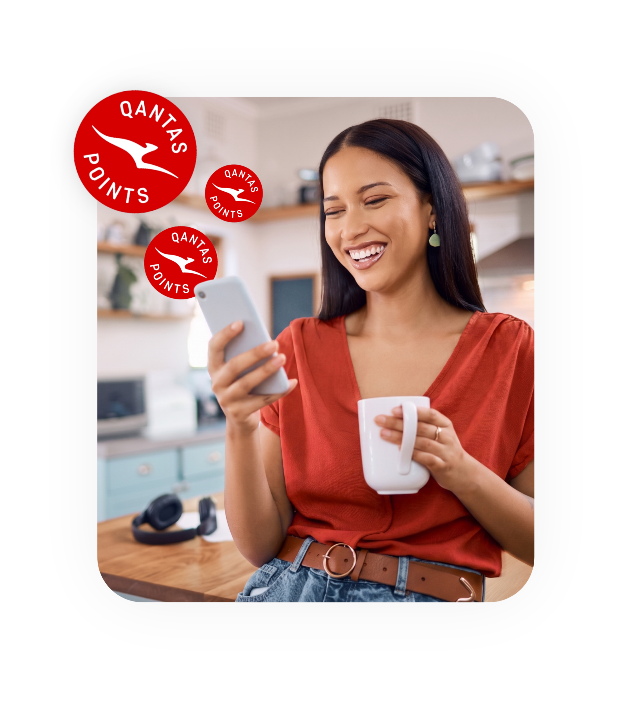 A person smiling at their phone with Qantas Points badges floating above it